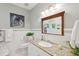 Classic bathroom featuring white subway tile, granite countertops, and a framed mirror at 4952 Steeplechase Ln, Hollywood, SC 29449
