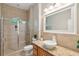 Neutral bathroom with a glass enclosed shower, granite vanity and decorative mirror at 4952 Steeplechase Ln, Hollywood, SC 29449