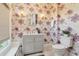 Charming powder room featuring floral wallpaper, vanity and toilet at 4952 Steeplechase Ln, Hollywood, SC 29449
