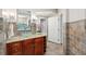 A well-lit bathroom with tile floors, granite countertop, glass bowl sink, and decorative tile at 4952 Steeplechase Ln, Hollywood, SC 29449