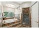 Bathroom with a tub, shower, and glass block window at 4952 Steeplechase Ln, Hollywood, SC 29449