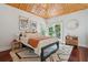 Cozy bedroom with a modern platform bed, wood floors, and a textured area rug at 4952 Steeplechase Ln, Hollywood, SC 29449