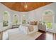 Bedroom with wood ceiling, three windows, hardwood floor, and bench at 4952 Steeplechase Ln, Hollywood, SC 29449