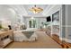 Well-lit bedroom featuring a seating area, entertainment center, and patio access at 4952 Steeplechase Ln, Hollywood, SC 29449