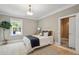Cozy bedroom featuring a full bed, neutral walls, and outdoor view of the swimming pool through the window at 4952 Steeplechase Ln, Hollywood, SC 29449