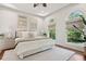 Bright bedroom features large windows, tray ceilings, and a plush queen size bed at 4952 Steeplechase Ln, Hollywood, SC 29449