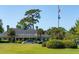 Well-maintained clubhouse with manicured landscaping, palm trees, and ample parking at 4952 Steeplechase Ln, Hollywood, SC 29449