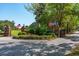 Welcoming entrance to a beautiful community, featuring decorative brick pillars and American flags at 4952 Steeplechase Ln, Hollywood, SC 29449