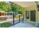 View from the porch featuring a fenced pool, covered seating area, and the home's back door at 4952 Steeplechase Ln, Hollywood, SC 29449