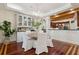 Dining room with adjacent kitchen, modern chandelier, and hardwood floors at 4952 Steeplechase Ln, Hollywood, SC 29449