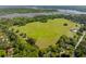 Aerial view of a large equestrian field surrounded by trees and greenery at 4952 Steeplechase Ln, Hollywood, SC 29449