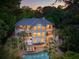 Elegant multi-story home boasting balconies, a pool, and meticulously landscaped grounds with mature trees at 4952 Steeplechase Ln, Hollywood, SC 29449