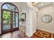 Grand foyer featuring decorative wood flooring, an elegant console table, and arched doorways at 4952 Steeplechase Ln, Hollywood, SC 29449