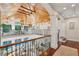 Spacious hallway with wood ceiling, iron railings, and access to seating area at 4952 Steeplechase Ln, Hollywood, SC 29449