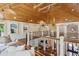 Upper hallway boasts wood ceilings, iron railings, with beach-themed paintings at 4952 Steeplechase Ln, Hollywood, SC 29449