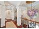 Hallway features white pillars, archways, and a unique purple chandelier at 4952 Steeplechase Ln, Hollywood, SC 29449