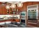 Kitchen with stainless steel appliances, custom cabinetry and granite countertops at 4952 Steeplechase Ln, Hollywood, SC 29449