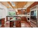 Gourmet kitchen showcasing custom cabinetry, stainless steel appliances, granite countertops, and hardwood floors at 4952 Steeplechase Ln, Hollywood, SC 29449