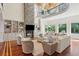 Bright living room featuring a stone fireplace, built-in shelving and seating area with wooded views at 4952 Steeplechase Ln, Hollywood, SC 29449