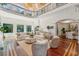Bright and airy living room with soaring ceilings, wrought iron balcony and views to the dining area at 4952 Steeplechase Ln, Hollywood, SC 29449