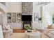 Living room with stone fireplace, built-in shelving and seating area at 4952 Steeplechase Ln, Hollywood, SC 29449