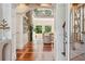 Open-concept living area with hardwood floors, stone fireplace, built-in shelving, and abundant natural light at 4952 Steeplechase Ln, Hollywood, SC 29449