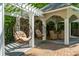 Beautiful outdoor space with hanging chairs, covered seating and dining areas, and landscaped yard at 4952 Steeplechase Ln, Hollywood, SC 29449