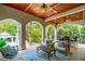 Covered patio area with dining and lounge seating overlooking yard at 4952 Steeplechase Ln, Hollywood, SC 29449