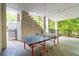 Recreational covered outdoor space with ping pong table, stairs, and view of the property at 4952 Steeplechase Ln, Hollywood, SC 29449