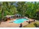 Aerial view of a private pool and cabana area surrounded by lush landscaping and lounge chairs at 4952 Steeplechase Ln, Hollywood, SC 29449