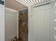 Outdoor shower space with tiled wall, shower head, and enclosed by white partition walls at 4952 Steeplechase Ln, Hollywood, SC 29449