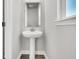 Bright bathroom with a pedestal sink, modern mirror, and natural light, creating a clean and inviting space at 5114 Double Eagle Loop, Summerville, SC 29485