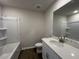 Modern bathroom features a shower-tub combo, white vanity with plenty of storage space, and tiled floors at 5114 Double Eagle Loop, Summerville, SC 29485