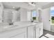 Bathroom featuring a double vanity with white cabinets, quartz countertop, and a glass shower at 5114 Double Eagle Loop, Summerville, SC 29485