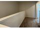 Upstairs hallway featuring carpet and white trim, offering a bright and open transition between spaces at 5114 Double Eagle Loop, Summerville, SC 29485