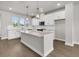 Bright and airy kitchen features stainless appliances, an island, hardwood floors, and natural light at 5114 Double Eagle Loop, Summerville, SC 29485