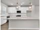New kitchen features island with pendant lights, white cabinets and stainless steel appliances at 5114 Double Eagle Loop, Summerville, SC 29485