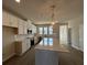 Well-lit kitchen featuring white cabinets, stainless steel appliances and a large center island at 5114 Double Eagle Loop, Summerville, SC 29485