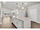 Spacious open concept kitchen features hardwood floors, white cabinets, and a center island at 5114 Double Eagle Loop, Summerville, SC 29485