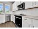 Modern kitchen boasts stainless appliances, hardwood floors, and white herringbone backsplash at 5114 Double Eagle Loop, Summerville, SC 29485