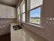 Kitchen featuring a stainless steel sink, white cabinets, and a view of the outdoors through the window at 5114 Double Eagle Loop, Summerville, SC 29485