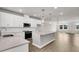 Bright, open kitchen features stainless appliances, island, pendant lights, and hardwood floors at 5114 Double Eagle Loop, Summerville, SC 29485