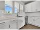 Modern kitchen features stainless appliances, white backsplash, quartz countertops, and hardwood floors at 5114 Double Eagle Loop, Summerville, SC 29485