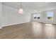 Bright living room boasts hardwood floors, neutral walls, and ample natural light from the large windows at 5114 Double Eagle Loop, Summerville, SC 29485