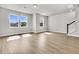 A modern living room with hardwood floors, neutral walls, and large windows offering plenty of natural light at 5114 Double Eagle Loop, Summerville, SC 29485