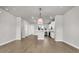 An open-concept living room with hardwood floors and easy access to a modern kitchen with stainless steel appliances at 5114 Double Eagle Loop, Summerville, SC 29485