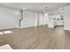 An open-concept living room with hardwood floors and easy access to a modern kitchen with stainless steel appliances at 5114 Double Eagle Loop, Summerville, SC 29485