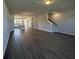 Open-concept living room with hardwood floors, view of kitchen and staircase at 5114 Double Eagle Loop, Summerville, SC 29485