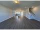 Expansive living area featuring hardwood floors, natural lighting, and a view of the kitchen at 5114 Double Eagle Loop, Summerville, SC 29485