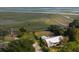 Scenic aerial view of house surrounded by lush marsh landscape with waterway at 561 Seaward Dr, Charleston, SC 29412